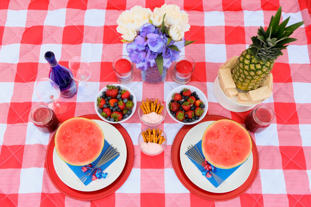 red, white and blue picnic on a red gingham blanket