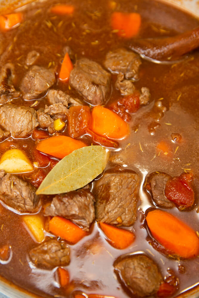 adding all ingredients for beef stew