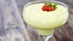 pineapple avocado smoothie in clear margarita glass