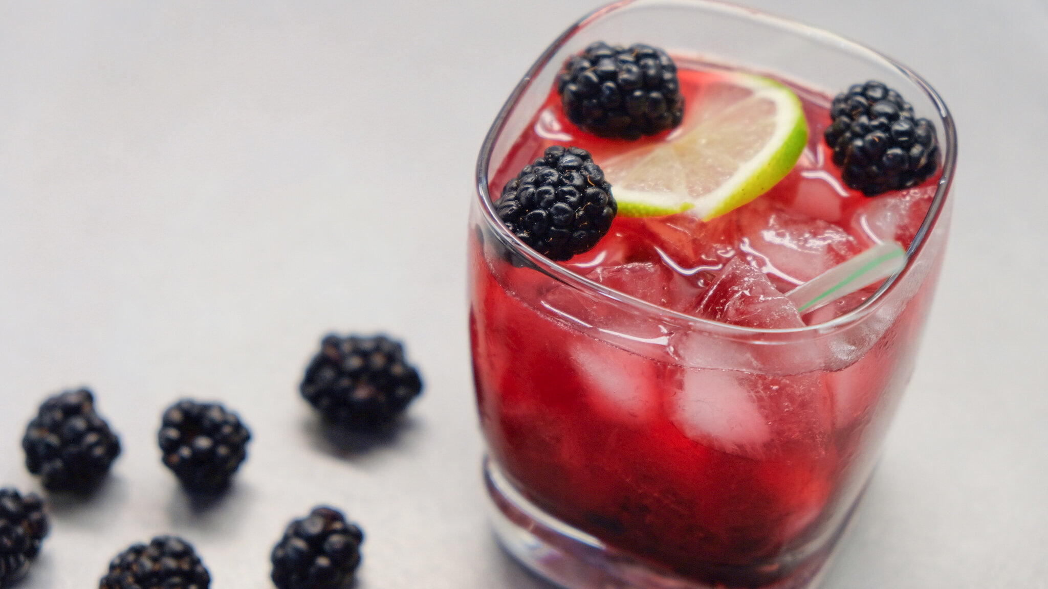 blackberry caipirinha cocktail in clear glass