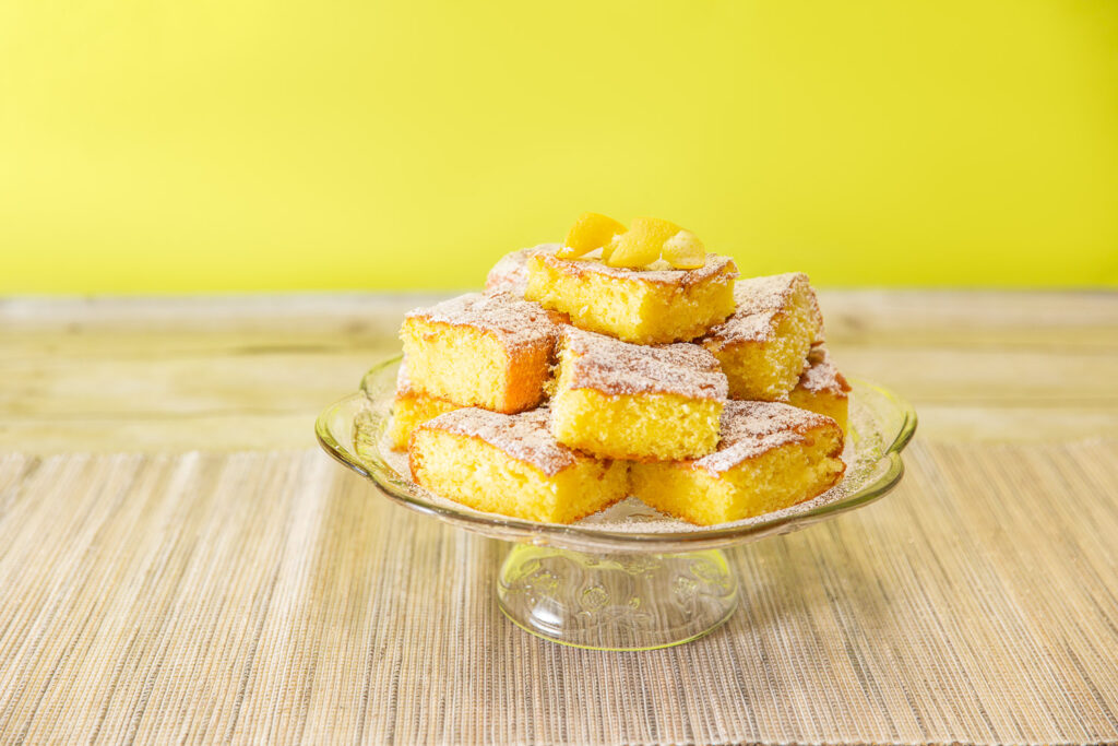 lemon cake squares on cake stand