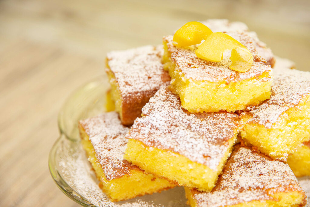 lemon cake squares on cake stand