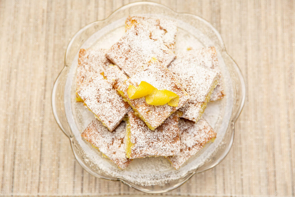 lemon cake squares on cake stand