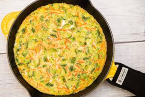 veggie frittata in a yellow le creuset cast iron skillet