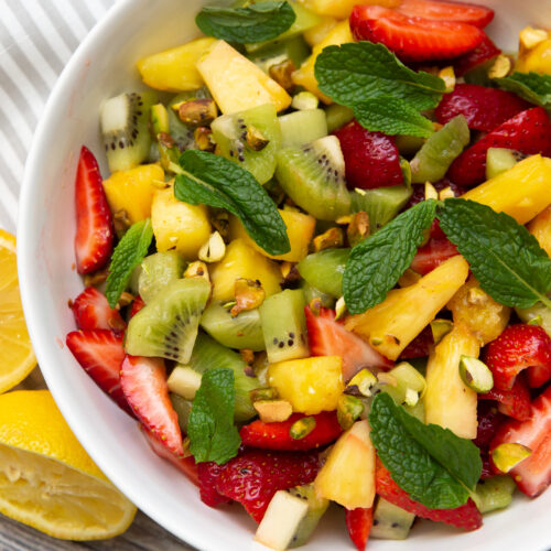 tropical fruit salad in a white bowl