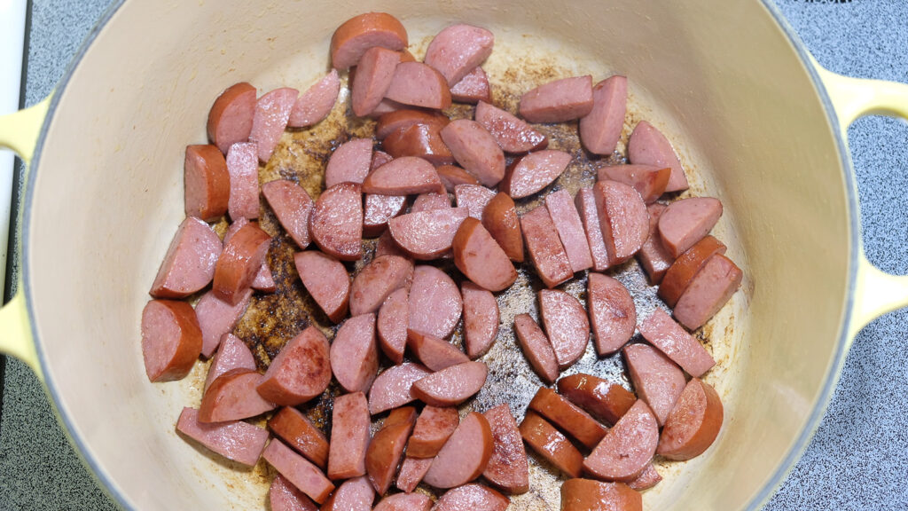 browning sausage in a pot