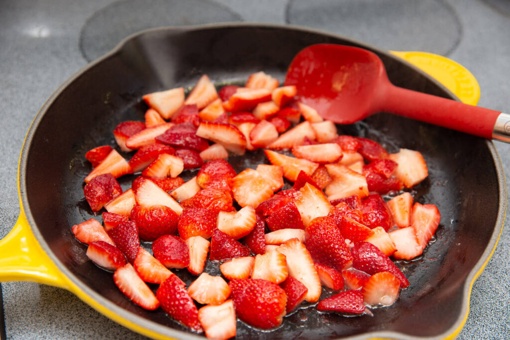 strawberries cooking in a yellow skillet