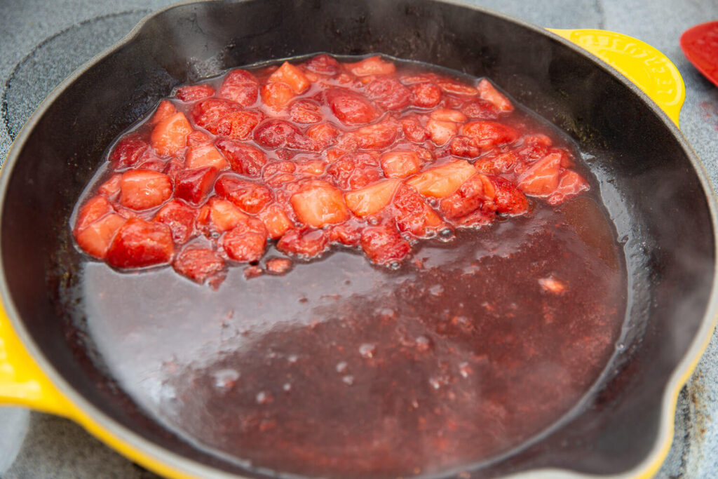 strawberries cooking in a yellow skillet