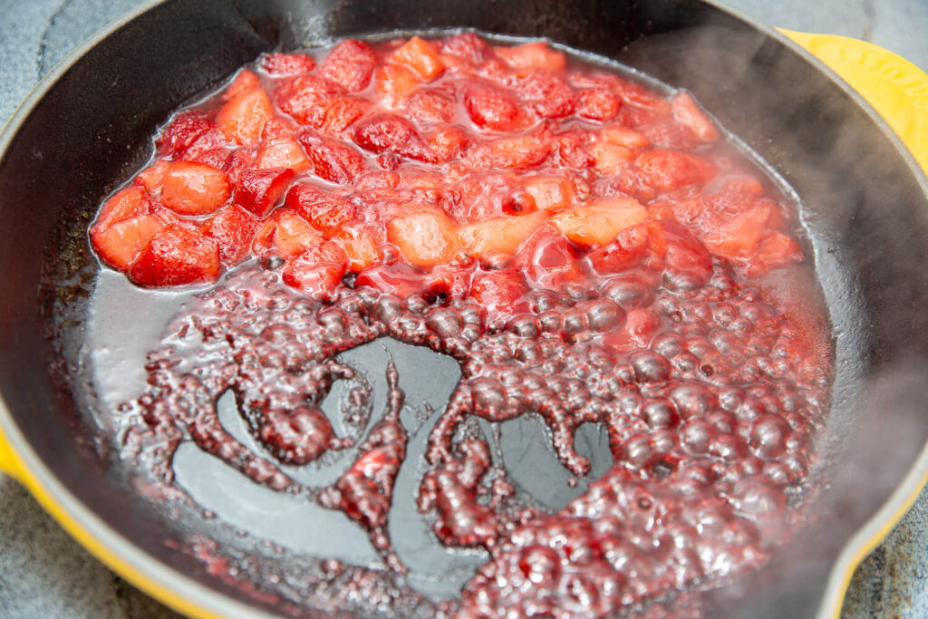 strawberries cooking in a yellow skillet