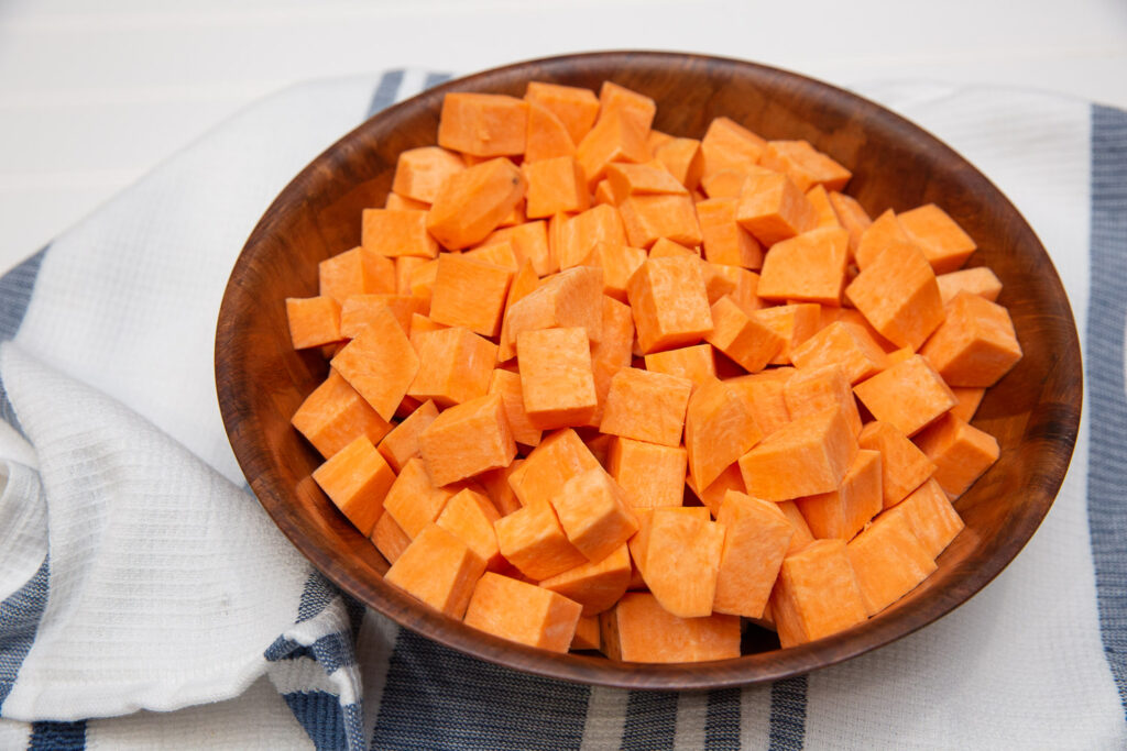 cubed sweet potatoes in a wood bowl