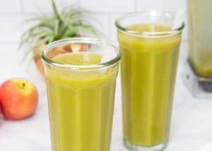 two green smoothies in tall glasses