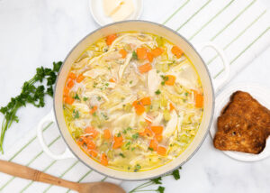 chicken noodle soup in a white bowl