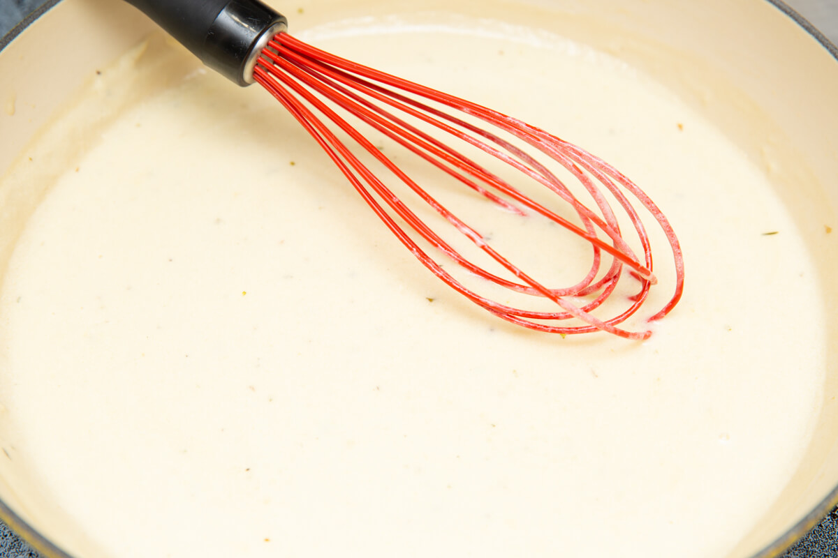 vegan alfredo sauce cooking in a skillet