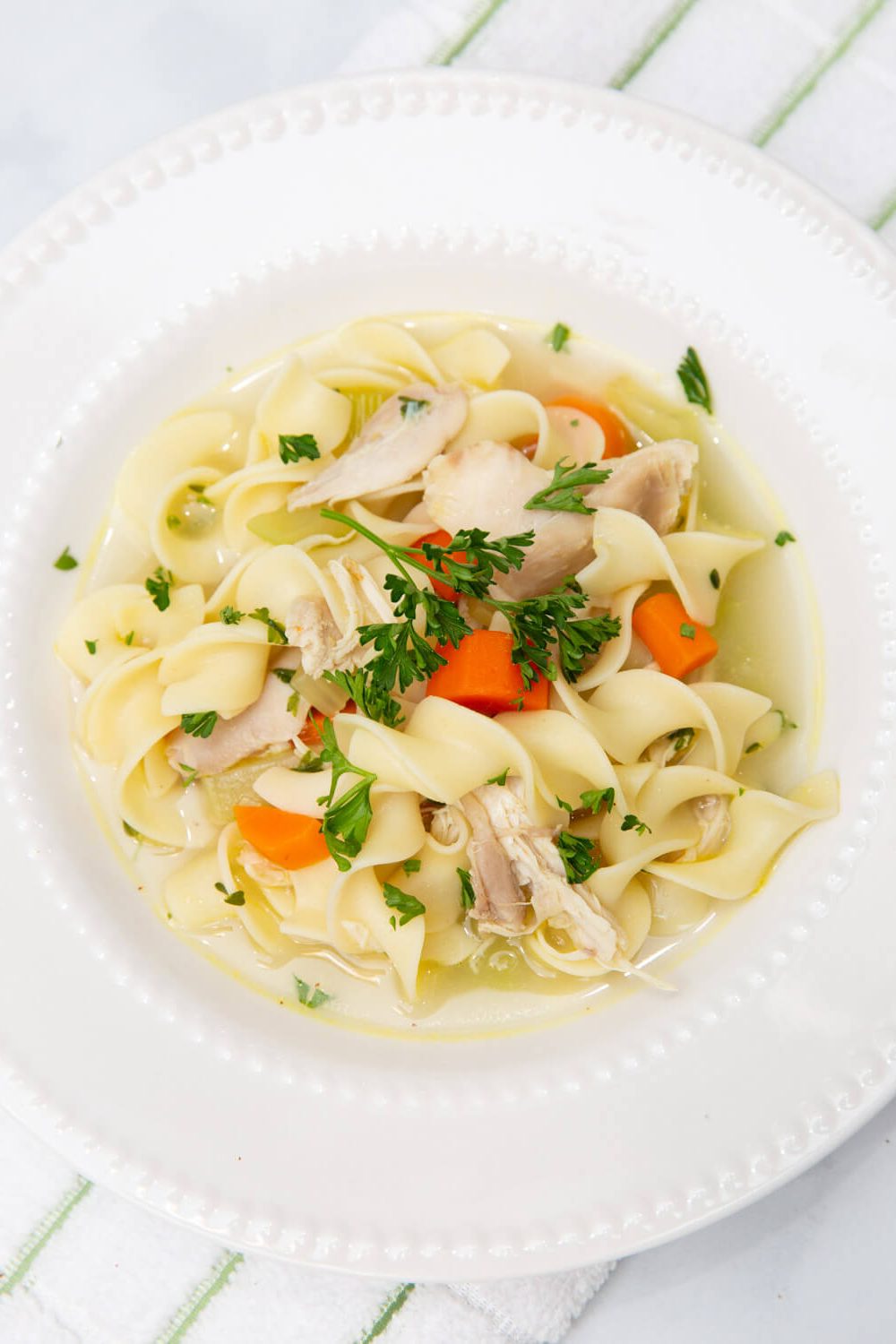 chicken noodle soup in a white bowl