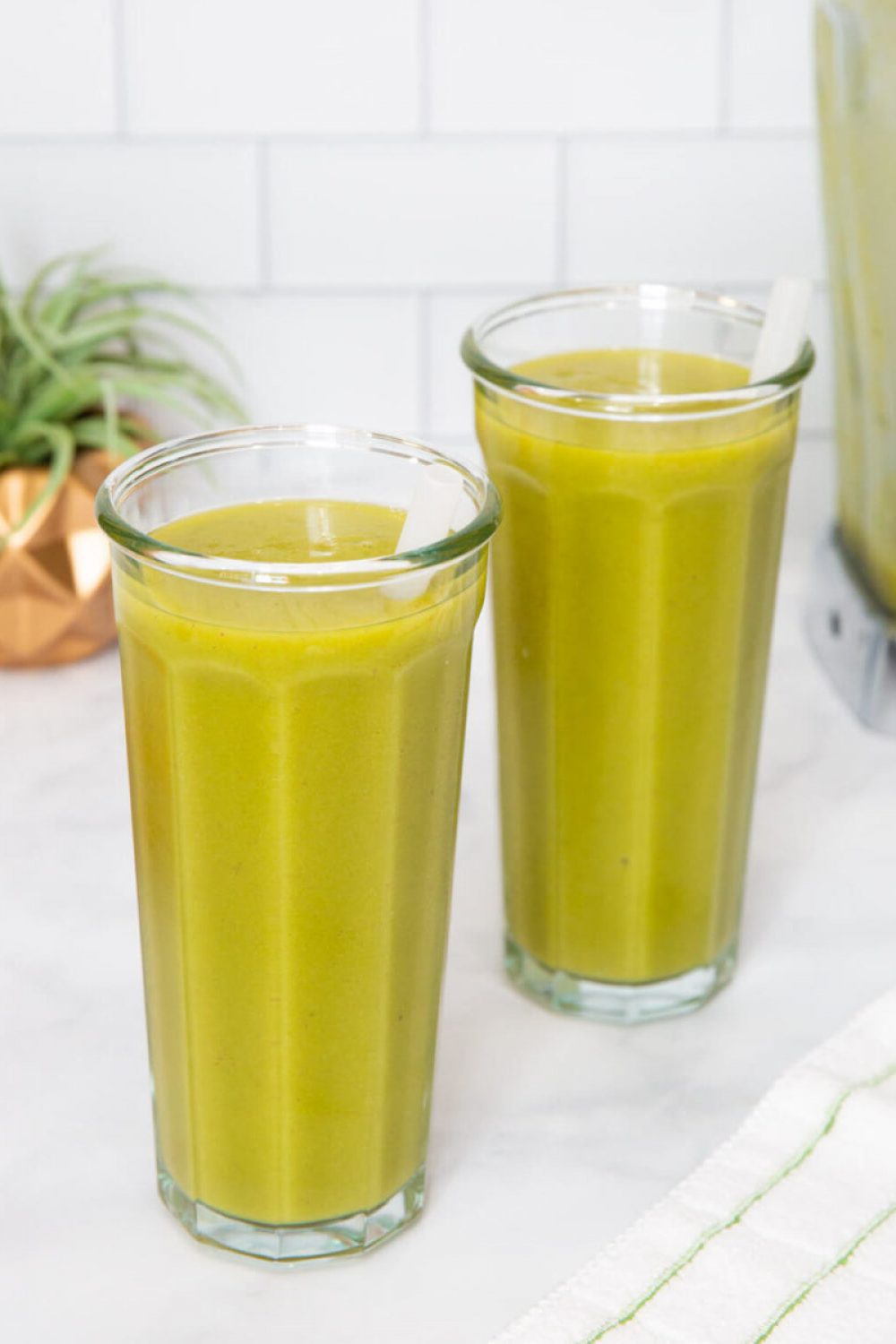 two green smoothies in tall glasses